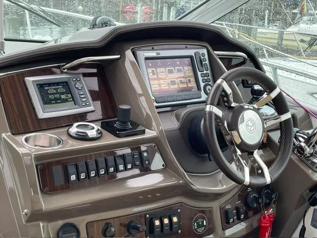 Slide: The Image of Helm of 2012 Cruisers Yachts 380 Express with advanced navigation controls and displays. - 3