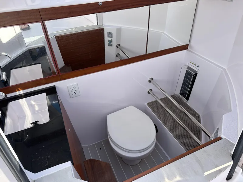 Slide: The Image of 2021 Axopar 28 Brabus T-Top boat bathroom with modern fixtures and sleek design. - 10