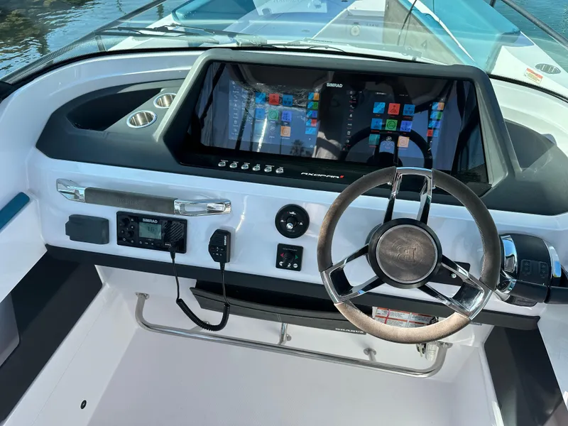 Slide: The Image of 2021 Axopar 28 Brabus T-Top helm with modern controls and touchscreen display. - 11