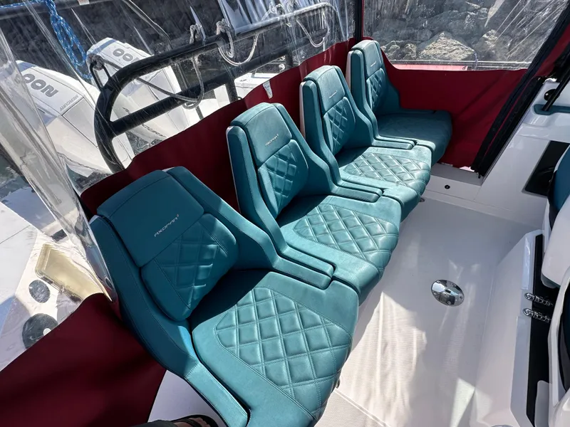 Slide: The Image of Luxurious seating on 2021 Axopar 28 Brabus T-Top with teal quilted upholstery. - 7
