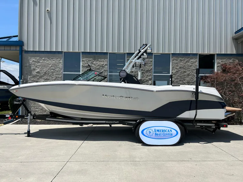 Slide: The Image of 2022 MasterCraft NXT24 boat on trailer outside American Boat Center. - 0