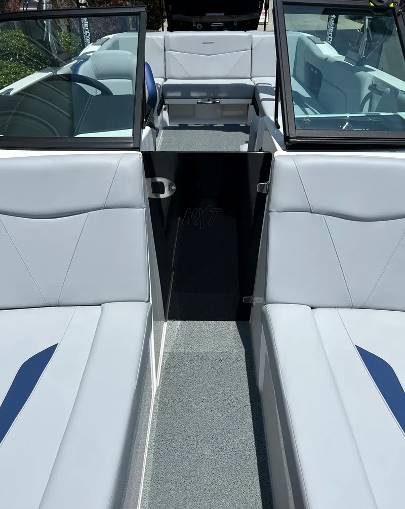 Slide: The Image of 2022 MasterCraft NXT24 boat interior with gray seating and open windshield. - 5