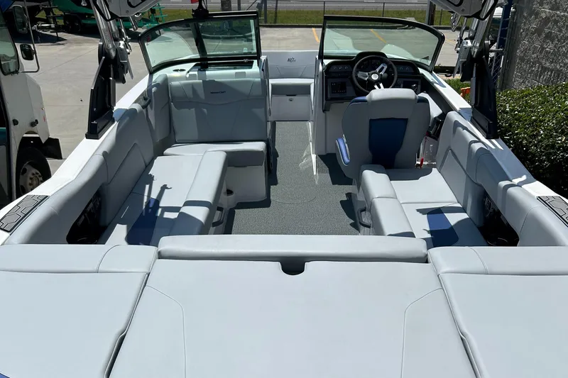 Slide: The Image of 2022 MasterCraft NXT24 boat interior with spacious seating and modern dashboard. - 6