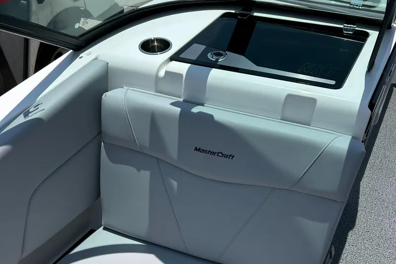 Slide: The Image of 2022 MasterCraft NXT24 boat interior with sleek seating and cup holder. - 8