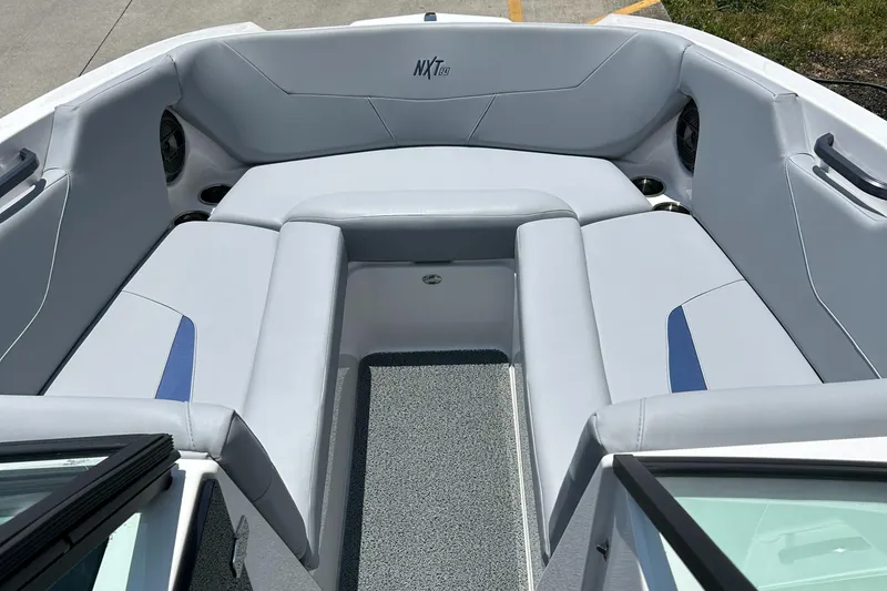 Slide: The Image of 2022 MasterCraft NXT24 boat interior with gray seating and blue accents. - 9