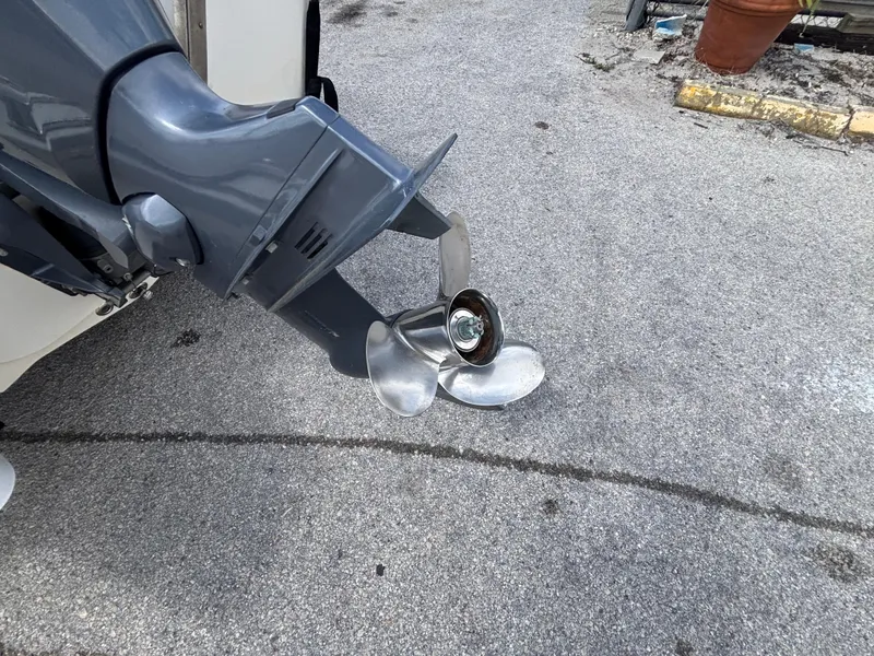 Slide: The Image of Damaged propeller of a 2018 Key West 1720 Sportsman boat on pavement. - 15