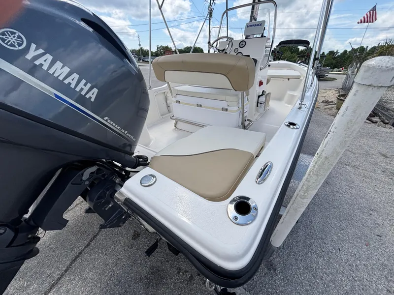 Slide: The Image of 2018 Key West 1720 Sportsman boat with Yamaha engine, docked on a sunny day. - 17