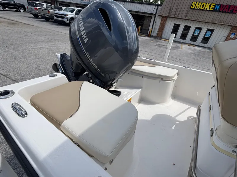 Slide: The Image of 2018 Key West 1720 Sportsman boat with Yamaha outboard motor, parked near a store. - 21