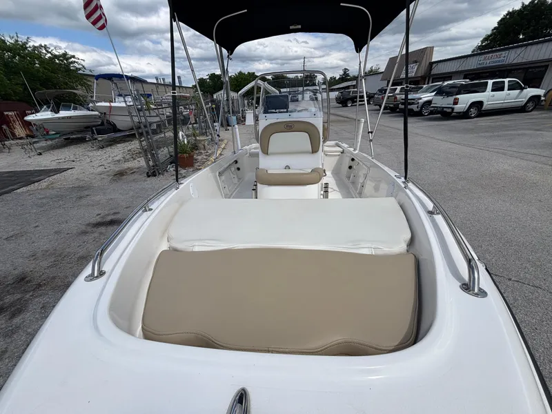 Slide: The Image of 2018 Key West 1720 Sportsman boat with beige seating, parked outdoors. - 4
