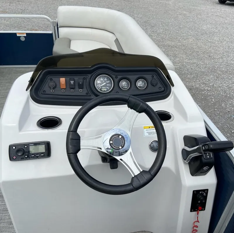 Slide: The Image of 2021 Godfrey Sweetwater 2286 SBX boat dashboard with steering wheel and controls. - 6