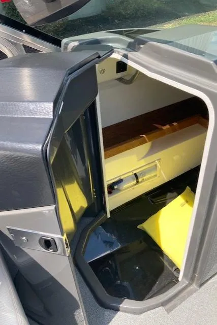 Slide: The Image of 2018 MasterCraft X26 storage compartment with yellow life jacket inside. - 11