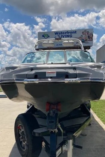 Slide: The Image of 2018 MasterCraft X26 boat on trailer under cloudy sky. - 5