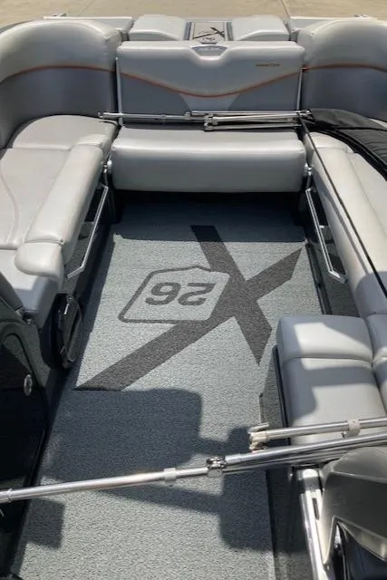 Slide: The Image of 2018 MasterCraft X26 boat interior with gray seating and custom flooring. - 8