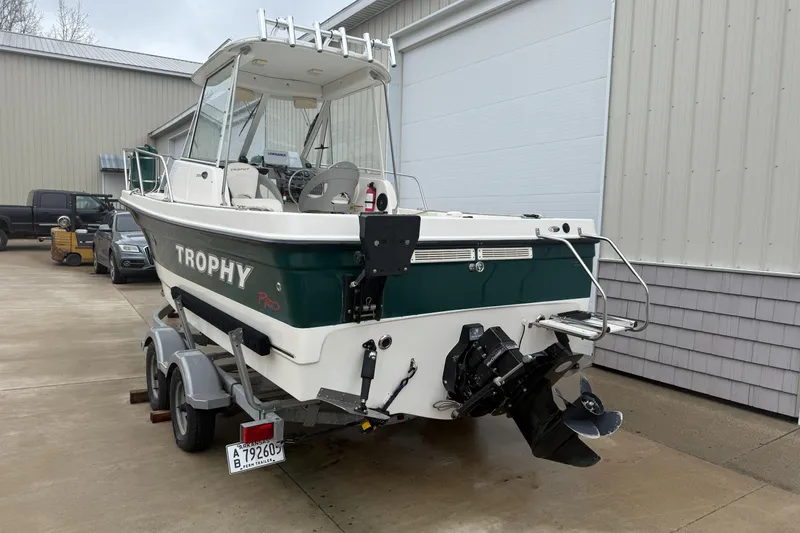 Slide: The Image of 2010 Trophy 2152 Walkaround boat on trailer, parked outside a warehouse. - 1