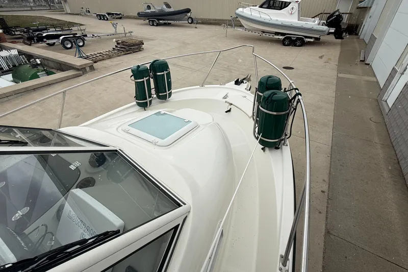 Slide: The Image of 2010 Trophy 2152 Walkaround boat on display in a marina setting. - 4