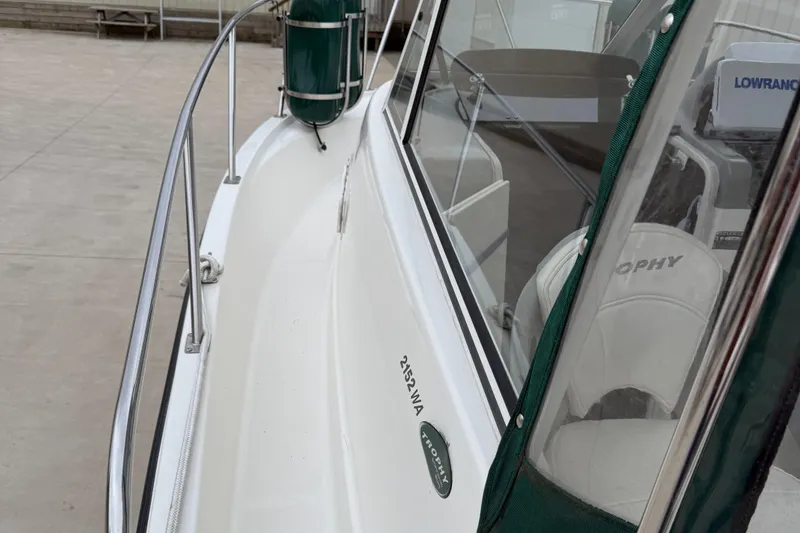 Slide: The Image of 2010 Trophy 2152 Walkaround boat, side view with railing and cockpit details. - 6