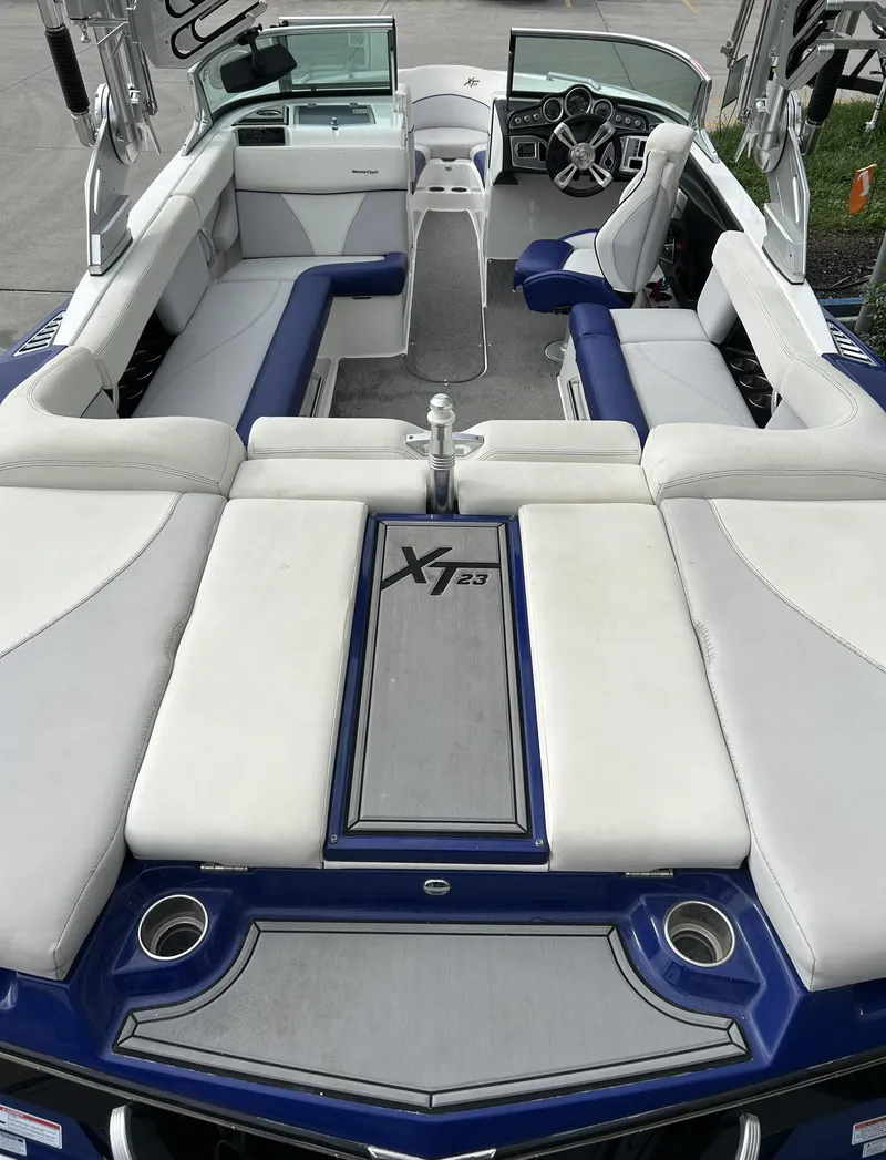 Slide: The Image of 2017 MasterCraft XT23 boat interior with white and blue seating. - 5