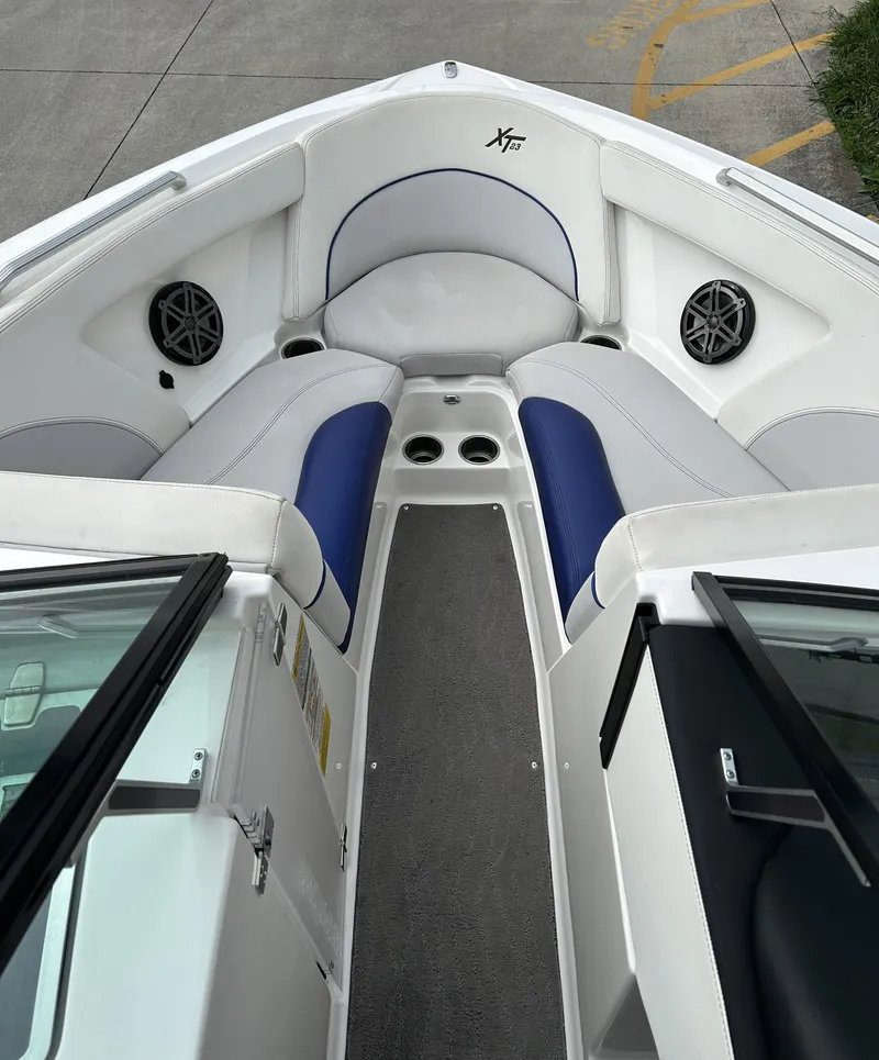Slide: The Image of 2017 MasterCraft XT23 boat interior with cushioned seating and speakers. - 6