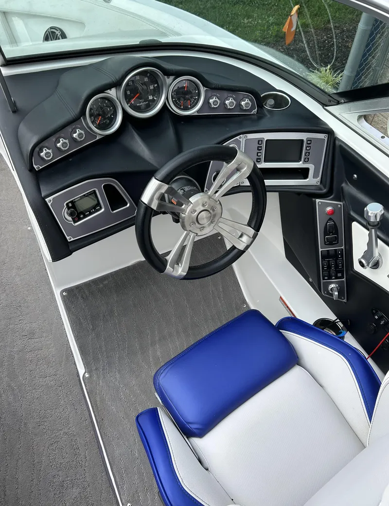 Slide: The Image of 2017 MasterCraft XT23 boat dashboard with steering wheel and control panel. - 9