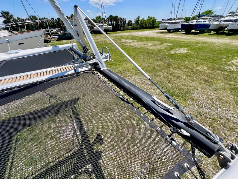 Slide: The Image of Voyage Yachts 500 catamaran, 2010 model, docked on grassy marina with other boats. - 10