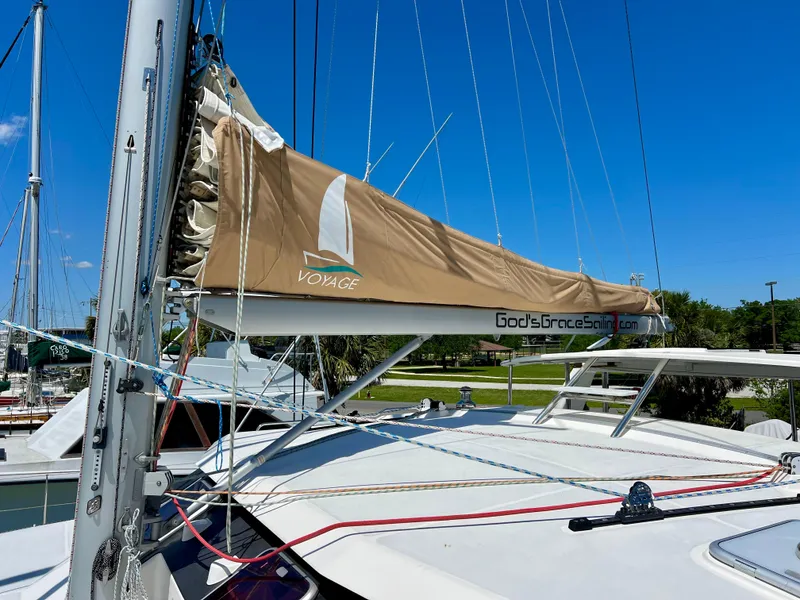 Slide: The Image of Sailboat Voyage Yachts 500, 2010 model, docked with tan sail cover under clear blue sky. - 11