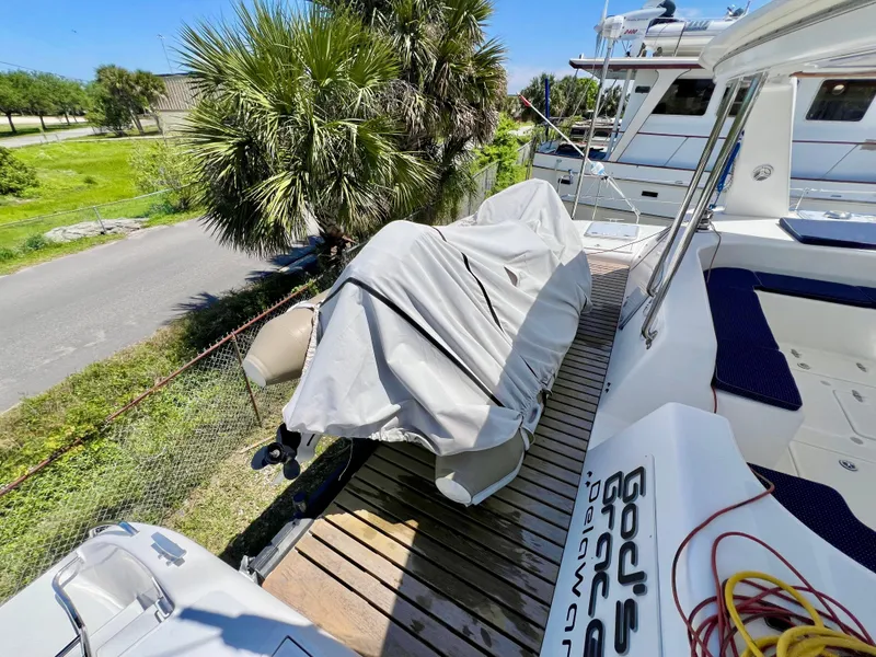 Slide: The Image of Voyage Yachts 500, 2010 model, docked with covered equipment, surrounded by lush greenery. - 17