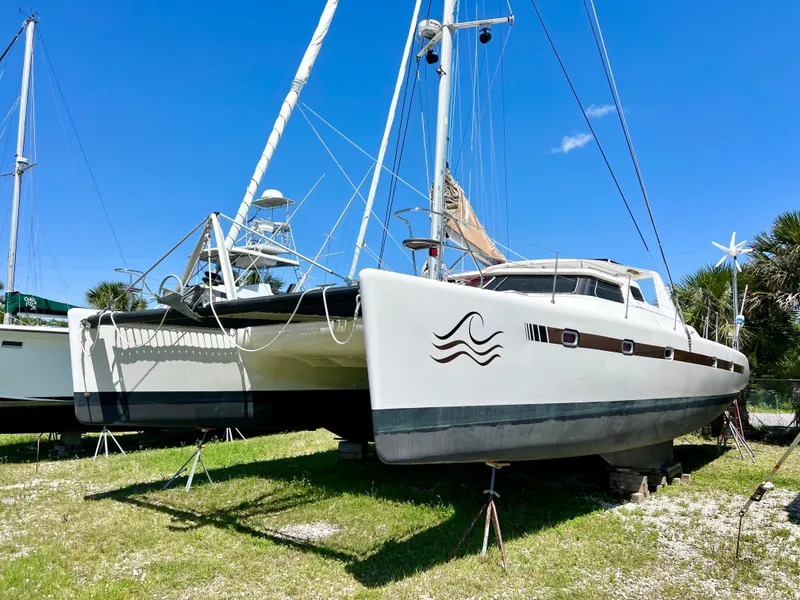 Slide: The Image of 2010 Voyage Yachts 500 catamaran on land, under clear blue sky. - 2