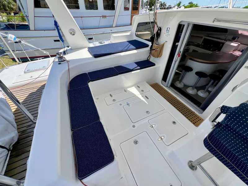 Slide: The Image of Spacious deck of 2010 Voyage Yachts 500 with blue cushioned seating and open cabin entrance. - 22
