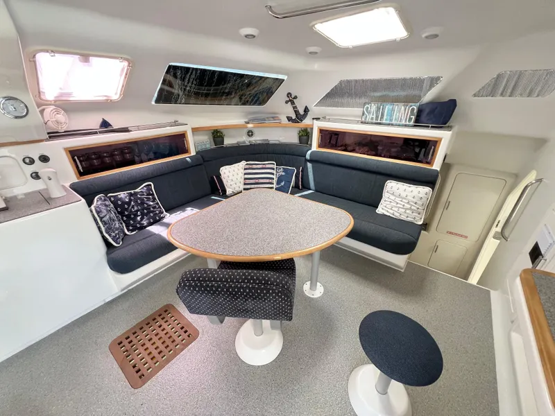 Slide: The Image of Interior of 2010 Voyage Yachts 500, featuring a cozy seating area with nautical decor. - 27