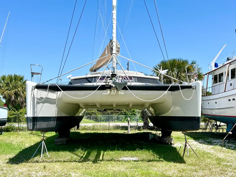 Slide: The Image of Voyage Yachts 500 catamaran from 2010 on land, under clear blue sky. - 3