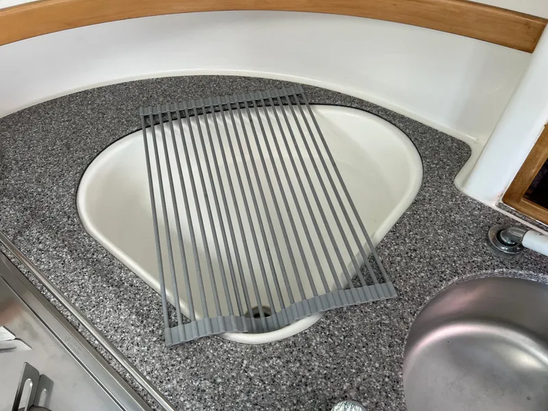 Slide: The Image of Kitchen sink area on a 2010 Voyage Yachts 500 with a roll-up dish rack. - 37