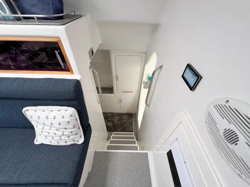 Slide: The Image of Interior of 2010 Voyage Yachts 500, featuring stairs, seating, and nautical-themed decor. - 41