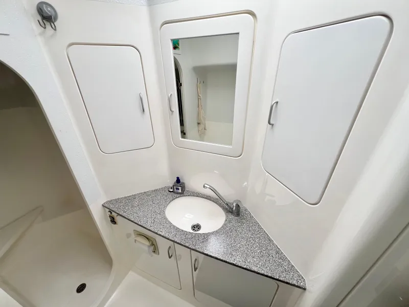 Slide: The Image of Bathroom interior of 2010 Voyage Yachts 500 with sink, mirror, and storage cabinets. - 43