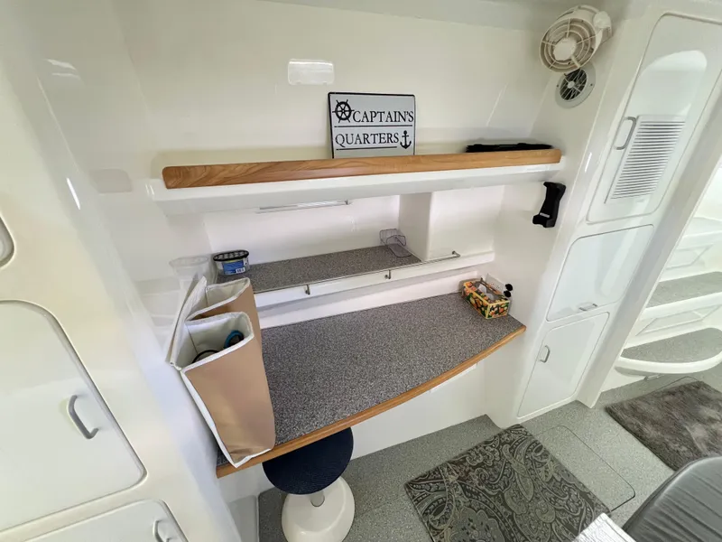 Slide: The Image of Captain's quarters workspace on 2010 Voyage Yachts 500, featuring desk, stool, and nautical decor. - 47
