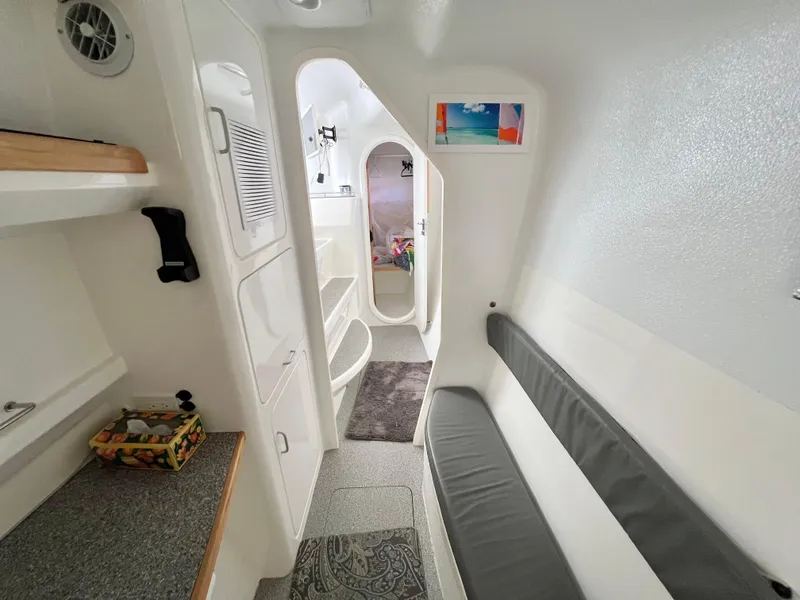 Slide: The Image of Interior of 2010 Voyage Yachts 500, featuring sleek white design and comfortable seating. - 48