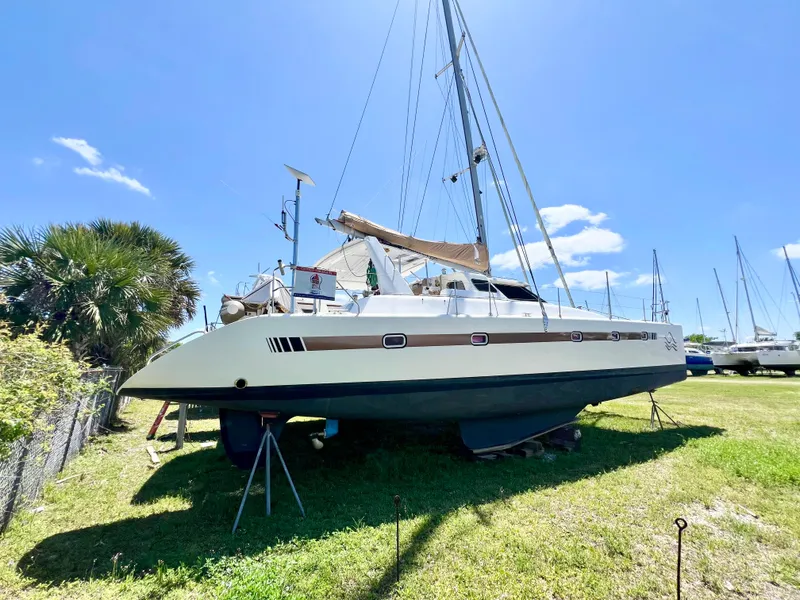Slide: The Image of Voyage Yachts 500 catamaran, 2010 model, on land under clear blue sky. - 5