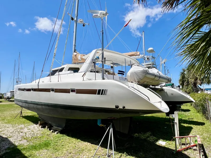 Slide: The Image of Voyage Yachts 500 catamaran, 2010 model, on land under clear blue sky. - 6