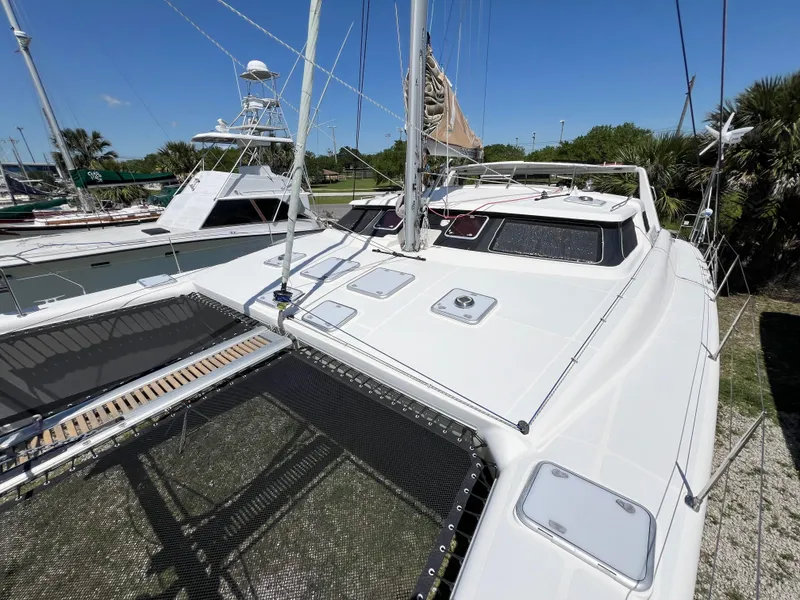 Slide: The Image of Sleek 2010 Voyage Yachts 500 catamaran docked under clear blue sky. - 7