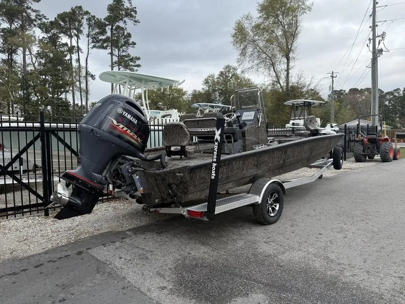 Slide: The Image of 2025 Xpress H22B Bay boat with Yamaha outboard motor on a trailer. - 3