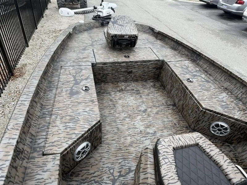 Slide: The Image of 2025 Xpress H22B Bay boat with camo design and spacious deck layout. - 5