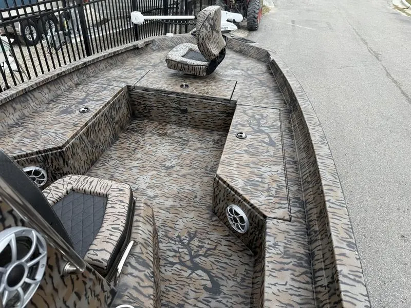 Slide: The Image of 2025 Xpress H22B Bay boat with camouflage design and modern seating. - 6