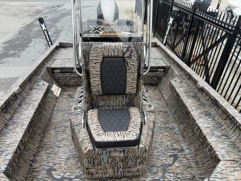 Slide: The Image of 2025 Xpress H22B Bay boat with camouflage seating and console design. - 7