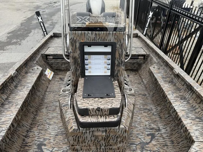 Slide: The Image of 2025 Xpress H22B Bay boat with camouflage interior and console display. - 8