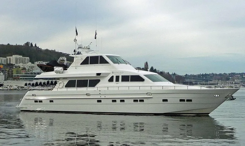 The Image of Luxury 2001 Horizon Skylounge yacht on calm water, with scenic background. - 0