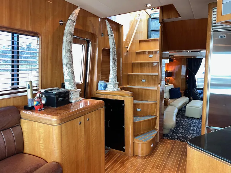 Slide: The Image of Luxurious 2001 Horizon Skylounge yacht interior with wooden staircase and elegant decor. - 15