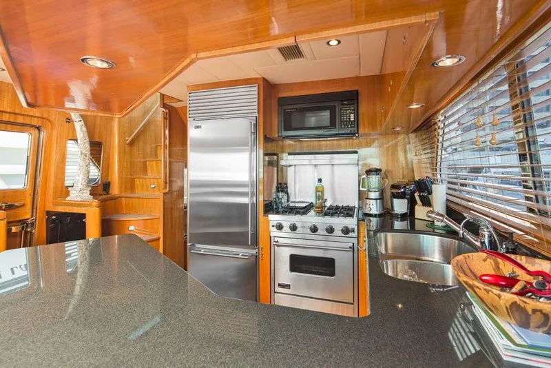 Slide: The Image of Luxurious yacht kitchen with modern appliances, wooden cabinetry, and sleek countertops, Horizon Skylounge 2001. - 17