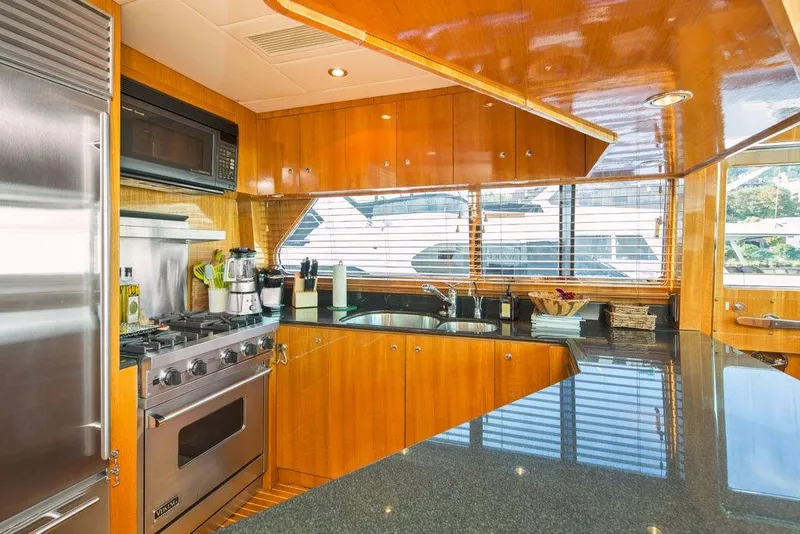 Slide: The Image of Luxurious kitchen interior of 2001 Horizon Skylounge yacht with modern appliances and wood finish. - 18