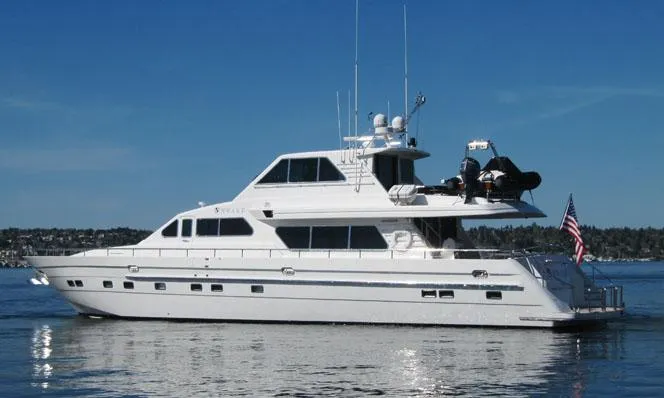 Slide: The Image of Luxury 2001 Horizon Skylounge yacht on calm water with clear blue sky. - 2