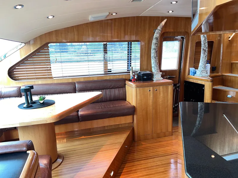 Slide: The Image of Luxurious 2001 Horizon Skylounge yacht interior with wooden finishes and leather seating. - 21