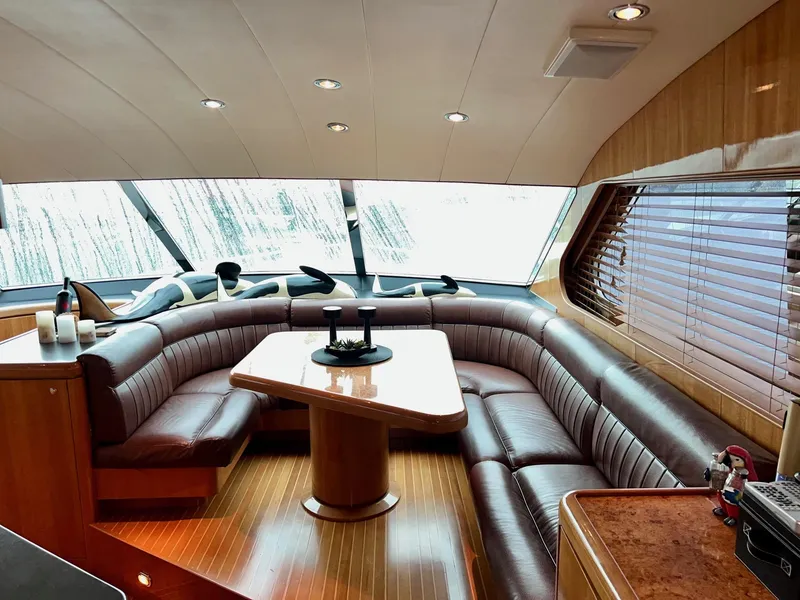 Slide: The Image of Luxurious 2001 Horizon Skylounge yacht interior with leather seating and wooden table. - 24